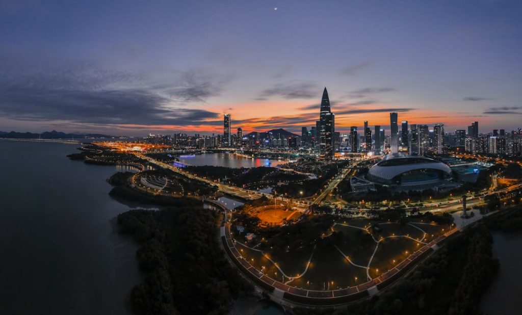 Photo by Weichao Deng an aerial view of a city at night